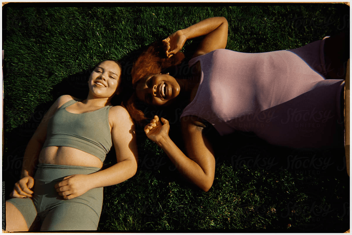 Two women relaxing together on the grass